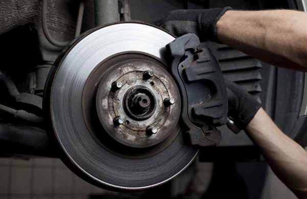 Closeup of car mechanic repairing brake pads